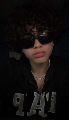 a woman wearing sunglasses and a hoodie with the word rap on it's chest