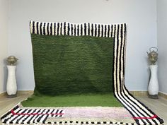 a green rug with black and white stripes on it