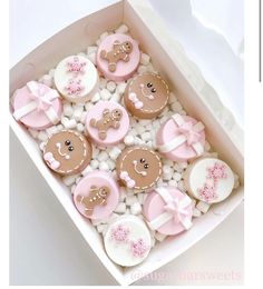 a box filled with lots of decorated cookies