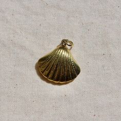 This charm is made of raw brass and is double-sided. The charm was produced in Taiwan in the 1980s. This charm is the perfect size for threading on a necklace chain at about 21mm in size Brass Shell, The 1980s, Double Face, Threading, Raw Brass, Necklace Chain, Vintage Charms, Charm Jewelry, Vintage Brass