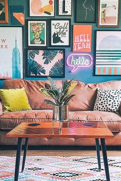 a living room filled with furniture and lots of pictures on the wall above it's coffee table