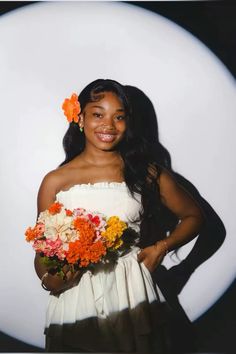 a woman in a white dress holding a bouquet of flowers