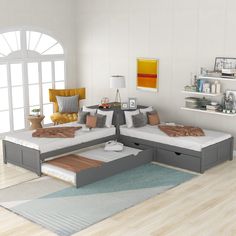 a living room filled with lots of furniture next to a white wall and wooden floor