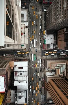 an aerial view of a city street with cars and trucks driving on it's sides