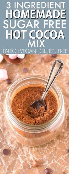 the ingredients to make homemade hot cocoa mix in a glass jar with a spoon on top