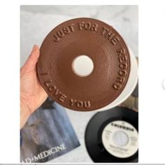 someone is holding up a chocolate donut with the words just for the record on it