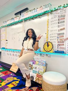 a woman standing in front of a whiteboard with lots of books on the wall