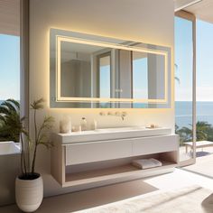 a bathroom with a large mirror and two sinks in front of a window overlooking the ocean