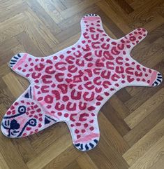 a pink and black animal rug on the floor