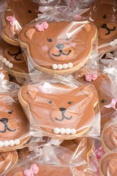 teddy bear cookies are wrapped in plastic and ready to be eaten at a party or baby shower