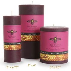 three bees waxed candles in different colors and sizes, with labels for each candle