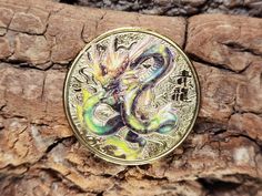 a coin with an image of a dragon on it sitting on a piece of wood