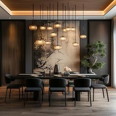 a dining room table with chairs and lights hanging from it's ceiling over the wooden floor