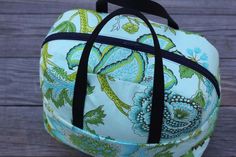 a blue and green bag sitting on top of a wooden table