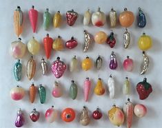 there are many different ornaments hanging on the wall in front of each other, including carrots and corn