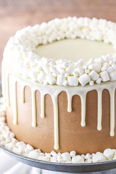 a cake with white icing and marshmallows on top