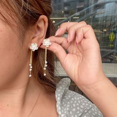 Adorn yourself with the grace and beauty of cherry blossoms with these exquisite White Sakura Flower Stud Earrings. Featuring delicate crystal tassel dangles, these earrings effortlessly combine elegance, daintiness, and uniqueness to create the perfect accessory for any occasion. Handcrafted with meticulous attention to detail, these stunning earrings are designed to make you feel like a blossoming cherry tree on a warm spring day. The perfect gift for a loved one or a special treat for yourself, these earrings are a must-have addition to any jewelry collection. Dainty Flower Shaped Earrings In Blossom, Formal White Flower-shaped Cluster Earrings, Cherry Blossom Jewelry Set, Sakura Flower Jewelry, Sakura Earrings, Sakura Flower, Warm Spring, Cherry Tree, Flower Earrings Studs