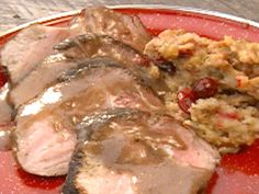 a red plate topped with meat covered in gravy