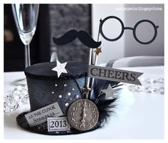 a table topped with a top hat and glasses