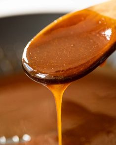 the spoon is full of caramel sauce