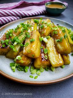 a plate that has some kind of food on it with onions and scallions