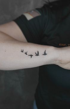 a woman's arm with birds on it