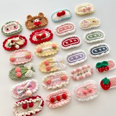 there are many crocheted hair clips on the table, including one with a teddy bear