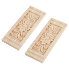 two carved wooden plaques with flowers on them