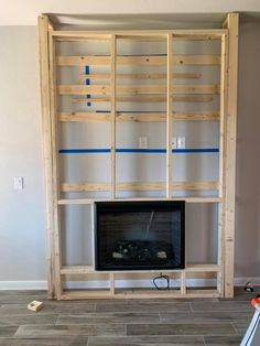 a living room with a fireplace and entertainment center built into the wall