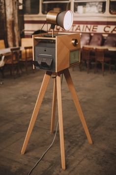 an old fashioned camera sitting on top of a tripod