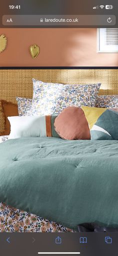 an image of a bed with many pillows on it