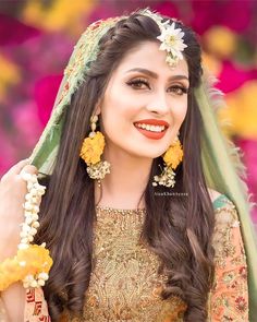 a woman in a bridal outfit with flowers on her head