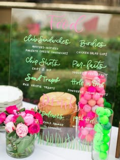 a table topped with lots of cakes and desserts on top of a white table cloth