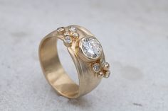 a gold ring with three diamonds on it