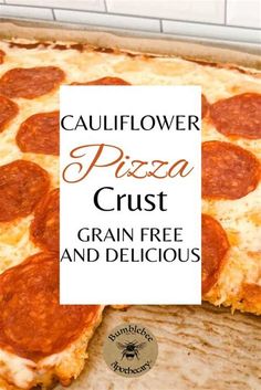 a close up of a pizza on a pan with the words cauliflower pizza crust grain free and delicious