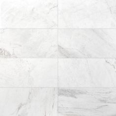 a white marble tile wall that looks like it has been cleaned and is being used as a floor covering