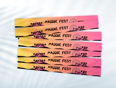 three pink and yellow tickets with the words maddie fest written on them in front of a white background