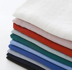 a stack of folded sheets sitting on top of each other