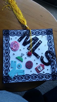 a wooden table topped with lots of assorted magnets on it's side