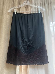 Very pretty retro black half slip without any tags.   It is in excellent condition. Waist measures 24 to 28" comfortably. About 36" around hips. 21" length. The front of the slip has a wide section of what I call 'old black lace'.   A little bit plum tones.  Lined behind lace so no lace is against the skin. A large stitched applique flower in front. Scalloped along the hemline. Wash by hand and hang to dry.   If you machine wash put into a mesh lingerie bag and only wash with other lingerie to keep lint from collecting on the lace. If I had to guess I'd say this was a Vanity Fair slip. Applique Flower, Half Slip, Lace Slip Dress, Lace Flower, Lace Slip, Flower Applique, Lace Flowers, Black Skirt, Vanity Fair