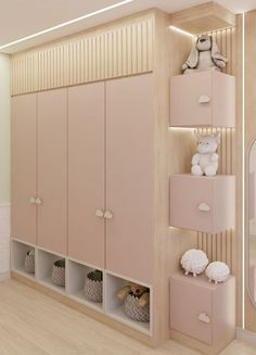 there is a room with pink cabinets and toys on the shelves in front of it