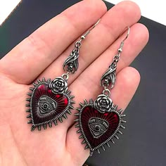 Brand New Boutique Item. Pair Of Red & Silver Metal Gothic Style Dangle Earrings That Feature Read Hearts With Spikes & A Silver Rose On Top, An Evil Eye In The Middle, & A Little Bat Hanging Upside Down From The Top Of Each Earring. See Pictures For Details. Tags: Goth Symbols Vampire Bat Jewelry Silver Heart-shaped Alloy Earrings, Heart-shaped Alloy Earrings For Gift, Valentine's Day Heart-shaped Alloy Earrings, Silver Gothic Earrings For Valentine's Day, Valentine's Day Party Earrings In Alloy, Valentine's Day Party Earrings Made Of Alloy, Red Metal Heart Earrings For Party, Red Heart-shaped Metal Earrings, Red Alloy Jewelry For Party