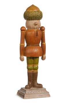 a wooden toy with a hat on it's head and arms, standing in front of a white background