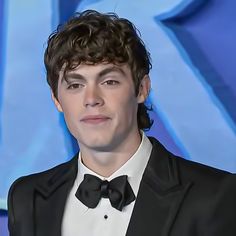 a young man wearing a tuxedo and bow tie