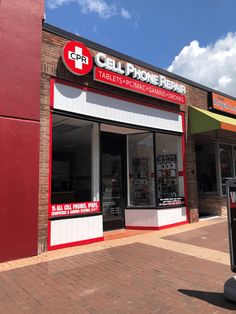 a red and white building with a sign that says cell phone repair