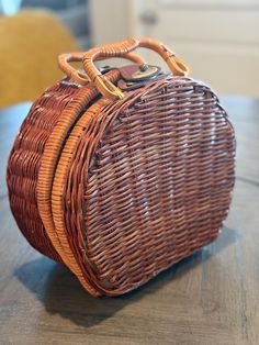 a wicker purse sitting on top of a wooden table