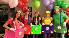 some people are dressed up as mario and luigi in costumes for a party with balloons