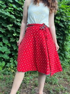 Are you in a blue floral mood or a red floral mood? With this reversible skirt from the 1970s, you can choose the color that suits your whims. It's like having two skirts in one!  This skirt does not have any labels and may have been homemade. It feels like cotton to me. So cute! Fits most similarly to a modern M. Since it's a wrap, it's very flexible and could likely work for a S or L as well. Please review measurements below.  Measurements Waist: 26-32 inches (adjustable) Length: 25.5 inches Condition: Excellent vintage condition. If you have any questions or need additional photos or measurements, please let me know. I'm happy to help! Thank you so much for shopping with Chloris Vintage. --Chandler Retro Red Summer Skirt, Red Casual Wrap Skirt For Summer, Casual Red Wrap Skirt For Summer, Retro Red Cotton Skirt, Retro Red Skirt For Spring, Red Lined Flared Wrap Skirt, Red Summer Wrap Skirt With Lining, Summer Red Fitted Wrap Skirt, Casual Red Flowy Wrap Skirt