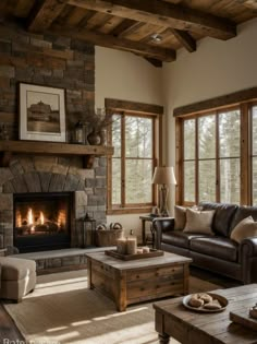 a living room filled with furniture and a fire place in front of a window covered in wood