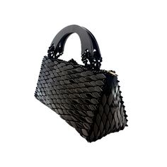 DESCRIPTION: The sleek black Roma handbag offers a stylish accessory option for various occasions. Its classic black color complements any outfit, while the spacious interior ensures you can carry all your essentials with ease. A versatile and timeless accessory that adds a touch of elegance to your look. Material: Exquisitely handcrafted by our master artisan piece by piece with natural beautifully hand carved recycled wood. Satin interior lining Dust bag included State of an art beaded shoulde Black Tote Evening Bag, Designer Handheld Evening Bag For Daily Use, Black Shoulder Bag With Top Handle, Black Business Satchel With Handles, Evening Tote With Detachable Strap, Modern Evening Satchel Bag, Luxury Handheld Clutch For Daily Use, Luxury Evening Bag For Daily Use, Luxury Black Box Bag For Daily Use